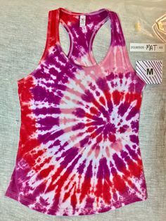 Medium ladies tie dyed racerback tank top Purple red pink and wine 60% cotton 40% polyester  Spiral / swirl pattern All of our shirts are made individually to be one-of-a-kind pieces. We can try to replicate patterns with any other colors, but cannot guarantee the same effects. Tie dyed t-shirts are unique, so what you see here is what you get - not something similar to this one, but THIS ONE. Multicolor Stretch Racerback Tank Top, Fitted Tie Dye Cotton Tank Top, Fitted Cotton Tie Dye Tank Top, Casual Purple Racerback Tank Top, Fitted Tie Dye Tank Top, Purple Stretch Racerback Tank Top, Swirl Pattern, Tie Dye T Shirts, Tie Dyed