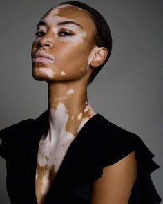 a woman with white and brown paint on her face