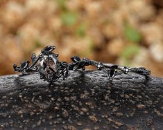 a close up of a ring on top of a rock