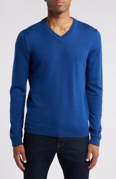 The only thing more wonderful than a smooth and polished-looking merino wool sweater is the fact that it's washable—your life just got easier! 28" length (size Medium) V-neck Ribbed cuffs and hem 100% merino wool Machine wash, dry flat Imported Men's Clothing Blue Merino Wool Fine Knit Sweater, Blue Fine Knit Merino Wool Sweater, Blue Fine Knit Merino Wool Top, Fine Knit Merino Wool Blue Top, Blue Merino Wool Top For Workwear, Blue Merino Wool Tops For Work, Blue Merino Wool Tops For Workwear, Blue Wool Fine Knit Tops, Blue Merino Wool Top For Fall