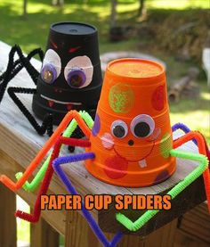 two paper cups with googly eyes and spider legs