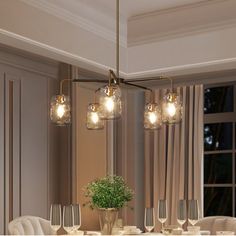 a dining room table with four chairs and a potted plant