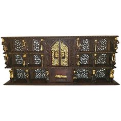 an ornate wooden shelf with gold decorations on it