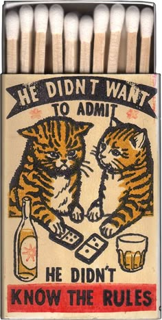 an old matchbox with two cats on it and the words, he didn't know