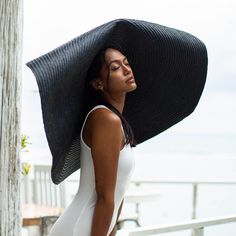 SOLANA Oversized Wide-brim Straw Hat is a statement piece that will keep the spotlight on you while enjoying the sun. Crafted from braided natural straw, the SOLANA hat has an oversized brim guaranteed to provide full coverage from the sun’s harsh rays. Fold the brim as needed to style.DETAILSComposition: 100% Natural StrawsThe brim measures approx 15” in lengthFull hat diameter measures approx 38.5”Slip-on, secure with chin strap Color: Black Designed in California, handmade by artisans in Bali Luxury Black Beach Hat, Black Straw Hat, Wide Brim Straw Hat, Enjoying The Sun, Independent Designers Fashion, British Indian, Wide Brimmed, Black Design, Straw Hat