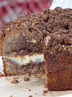 a close up of a piece of cake on a cutting board with one slice missing