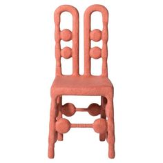 a pink chair that is made out of foam and has balls on the back of it