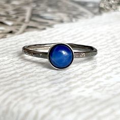 A delicate simple AG925 sterling silver ring, with a round eyelet of synthetic Star Sapphire set in a silver AG925 bed. The ring is AG925 silver, with a single bezel with a hammered look, patinated, in a solid size 56 mm (7.5 US) Nice small cute Gift box and also small Jewelry Gift is included. oooooooo          ... UNIQUE JEWELRY FOR UNIQUE WOMAN ... oooooooo Details: oº Fixed size : US 7.5 (56 mm) oº Semi-precious gemstone - Star Sapphire oº Sapphire diameter 6.2 mm oº Sterling Silver 925 oooo Celestial Sterling Silver Sapphire Promise Ring, Celestial Silver Stackable Rings, Silver Stackable Round Sapphire Ring, Hypoallergenic Silver Birthstone Ring In Sterling Silver, Hypoallergenic Silver Sterling Silver Birthstone Ring, Nickel-free Sterling Silver Celestial Rings, Celestial Style Sapphire Ring In Sterling Silver, Adjustable Silver Sapphire Ring, Sterling Silver Celestial Midi Rings