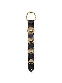 a keychain with four brass bells hanging from it's side on a white background