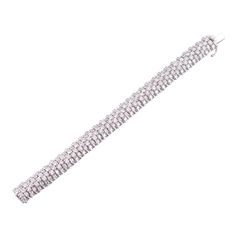 Exquisite 13ctw G/VS diamond bracelet in 18k white gold. DESIGNER: Not Signed MATERIAL: 18k Gold GEMSTONES: Diamond DIMENSIONS: Bracelet is 6 5/8" long and 11.5mm wide. Thickness 8.7mm. MARKED/TESTED: 750, 3583AL. WEIGHT: 59 grams CONDITION: Previously Owned/Excellent Condition Diamond White Platinum Bracelet With Baguette Diamonds, Platinum Diamond Bracelet With Baguette Diamonds In Diamond White, White Platinum Diamond Jubilee Bracelet, White Platinum Jubilee Diamond Bracelet, White Diamond Bracelet With Jubilee Design, Silver Bracelets With Baguette Diamonds, Silver Baguette Diamond Tennis Bracelet For Wedding, Dazzling Silver Diamond Bracelet In Platinum, Silver Bracelets With Baguette Diamonds For Wedding