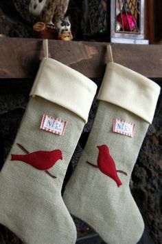 two christmas stockings with red birds on them