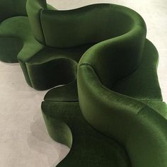 three green chairs sitting next to each other on a white floor