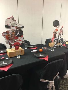 the table is set up for an event with decorations and sports themed items on it