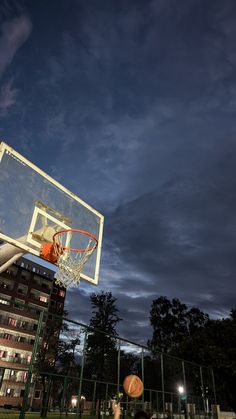 a basketball going through the hoop at night