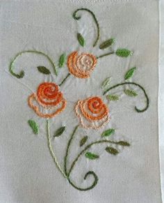 an embroidered piece of cloth with flowers on it