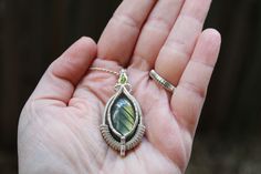 This stunning wire wrap pendant was hand-crafted using a green labradorite cabochon with a shimmering green peridot facet. These have been whimsically wrapped up in .925 sterling silver wire using intricate patterns and details.  Dimensions:   L* ~1.80 inches  W* ~1.0 inches *Silver chain sold separately* "Mindful Meandering Creations is my way of expressing creativity and sharing the love and power that working with crystals brings. I hope that through mindful practices we all as humans can come together to continue to make the world a beautiful place to call home." Kory D. Delannoy Wire Wrapped Green Sterling Silver Jewelry, Green Wire Wrapped Sterling Silver Jewelry, Green Sterling Silver Wire Wrapped Jewelry, Green Peridot Wire Wrapped Jewelry, Hand Wrapped Green Sterling Silver Jewelry, Handmade Green Labradorite Jewelry, Handmade Peridot Pendant Jewelry, Green Labradorite Wire Wrapped Jewelry, Mindful Practices