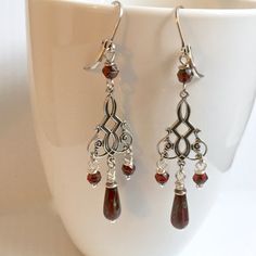 "Red and Silver Earrings - Antiqued Silver Plated Stampings with Dark Cranberry Red Czech Glass Teardrops with a Picasso finish and Faceted Dark Cranberry Red Glass Beads. These earrings are lightweight for easy wearing The earrings measure just over 2.75\" from top of earwires to bottom Antiqued Silver Plated Leverback Earwires" Red Teardrop Chandelier Earrings As Gift, Red Nickel-free Chandelier Earrings As Gift, Red Elegant Nickel-free Teardrop Earrings, Elegant Red Teardrop Beaded Earrings, Red Teardrop Chandelier Earrings With Ear Wire, Red Teardrop Chandelier Earrings, Nickel Free Elegant Red Chandelier Earrings, Elegant Nickel-free Red Chandelier Earrings, Red Nickel Free Drop Chandelier Earrings