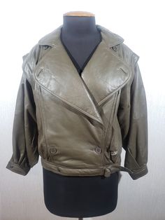 Charming brown leather jacket for women. Double-breasted brown leather jacket with a cropped silhouette. A wonderful leather jacket made of durable soft brown genuine leather. The jacket fastens easily with plastic buttons and is tied with a leather belt with metal half-rings, as well as with a metal snap at the bottom. In the lower part of the jacket there are two convenient pockets. The cuffs of the jacket are fastened with metal snaps. The jacket has a nice polyester lining. The jacket has a shortened silhouette and enlarged shoulders, which turn into a sleeve, which, if you spread your arms to the side, resembles a bat. Such a cut will perfectly emphasize your courage, independence and strength, leaving tenderness and elegance. The jacket is elegant, light and pleasant to wear. The jac Chic Brown Leather Biker Jacket, Brown Leather Long Sleeve Cropped Jacket, Brown Leather Cropped Jacket With Long Sleeves, Chic Brown Leather Cropped Jacket, Half Rings, Women Leather Vest, Leather Jacket For Women, Jacket For Women, Soft Brown