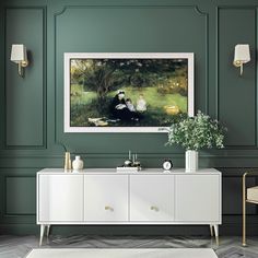 a painting hangs on the wall above a white sideboard with two vases and a potted plant