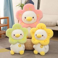 three stuffed animals sitting on top of a rug