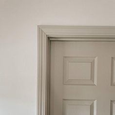 an open door in a room with white walls