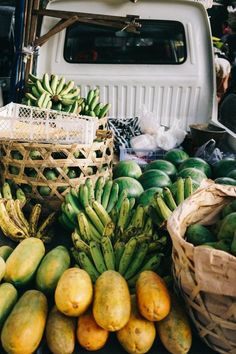 there are many different types of fruit on display in the back of a pickup truck