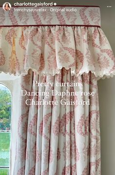 a window with pink and white curtains on it