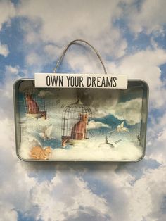 there is a sign that says own your dreams on the sky with birds flying around