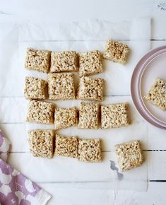 several squares of oatmeal are arranged on a table next to a plate