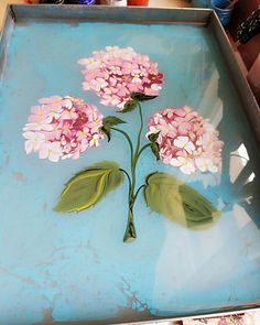 a tray with flowers painted on it in the process of being made into a painting