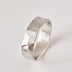 This hammered texture silver ring has a really unique rustic look. I make the simple ring band by hand using traditional metalsmith techniques and then use a flat hammer to create subtle shapes and organic textures. Each ring will have a completely unique finish so your ring will be one of a kind! This hammered style is different from my other hammered rings as the flat rather than round end of the hammer is used.  I think the result is a more subtle, natural shape and a weathered texture simila Etsy Rings Silver, Hammered Ring Men, Rustic Wedding Band, Simple Ring Band, Silver Hammered Ring, Rustic Wedding Bands, Art Clay Silver, Hammered Gold Ring, Rustic Rings