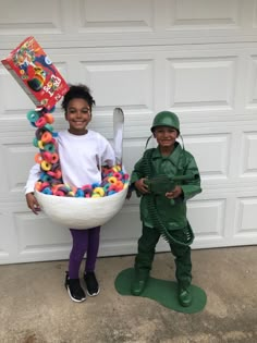 two children dressed up as toy soldiers and one is holding a large basket full of doughnuts