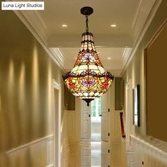 a hallway with a chandelier hanging from the ceiling