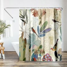 a shower curtain with birds and flowers on it in a white room next to a chair