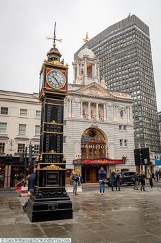 a clock tower in the middle of a city square