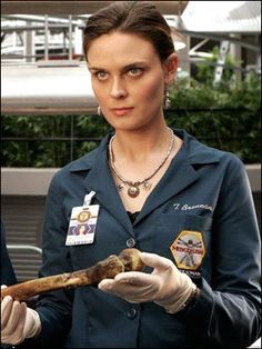 a woman in uniform holding a large bone