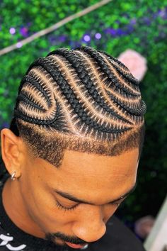 This fashionable hairstyle showcases meticulously braided rows that curve and intersect, creating an intricate, geometric pattern. The braids originate from the hairline and extend backward, highlighting the precision of the design and the skill required to achieve this high-fashion look. Complementing the overall aesthetic, the - Click to see more of Captivating Braided Looks: 30 Stylish Inspirations for Men and follow us for more hairstyle ideas. // Photo Credit: Instagram @dazjanique17 Men All Back Hairstyle, Man's Braids Hairstyles, Men’s Cornrows Hairstyles, Braided Hairstyles Black Man, Male Cornrows Braids For Men, Cornrows For Men Styles, Men’s Braid Designs, Mens Hair Ideas, Mens Hairstyles Cornrows