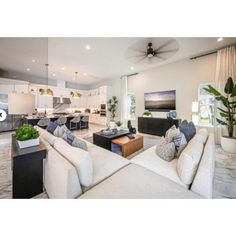 a living room filled with furniture and a ceiling fan