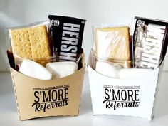 two small boxes filled with marshmallows and s'more refreshments