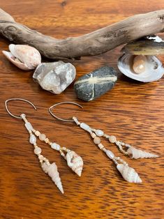 The 'Mermaid's Delight' earrings will transport you to a warm day at the coast with your toes in the sand and the sunlight glinting off the waves. Two different small shells dangle at the bottom of each earring. Mother of pearl, freshwater pearl, heishi shell, and peach and cream colored round shell beads, and white, matte cream, and reflective gold glass seed beads decorate them. They are light weight, unique, and made with beautiful natural treasures. You may not be able to be at the beach everyday, but you can wear a little bit of it through your everyday life! Shell Beaded Jewelry, Beaded Shell Earrings, Dangle Shell Earrings With Pearl Drop, Dangle Pearl Drop Shell Earrings, Pearl Drop Dangle Shell, Beach Earrings With Dangling Beads, Dangle Shell Pearl Earrings, Bohemian Shell Dangle Earrings, Handmade Shell Pearl Dangle Earrings