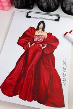 a drawing of a woman in a red dress on a piece of paper next to shoes