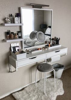 there is a vanity with a mirror and stool in the corner, along with other items