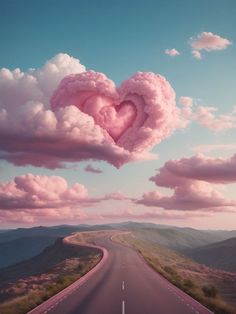 a heart shaped cloud floating in the air over a road