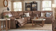 a living room filled with lots of furniture next to a wall mounted clock on the wall