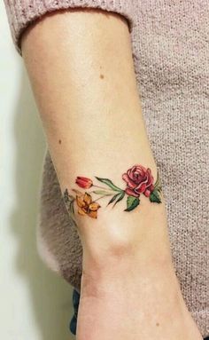 a woman with a flower tattoo on her wrist