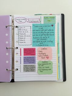 an open planner with notes and stickers on it