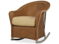 a wicker rocking chair with beige cushions