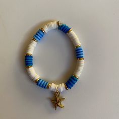 Blue & white themed starfish charm bracelet Adjustable Blue Bracelets With Starfish Charm, Adjustable Blue Jewelry With Starfish Charm, Adjustable Blue Starfish Jewelry, Blue Bracelets With Starfish Charm Ocean-inspired, Blue Beaded Bracelet With Starfish Charm, Ocean-inspired Blue Starfish Bracelets, Blue Beaded Bracelets With Starfish Charm, White Star-shaped Ocean-inspired Jewelry, Ocean-inspired White Star Jewelry