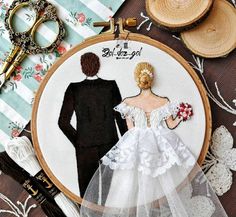 a cross stitch wedding dress and groom on a table