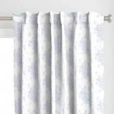 a white curtain with blue flowers on it